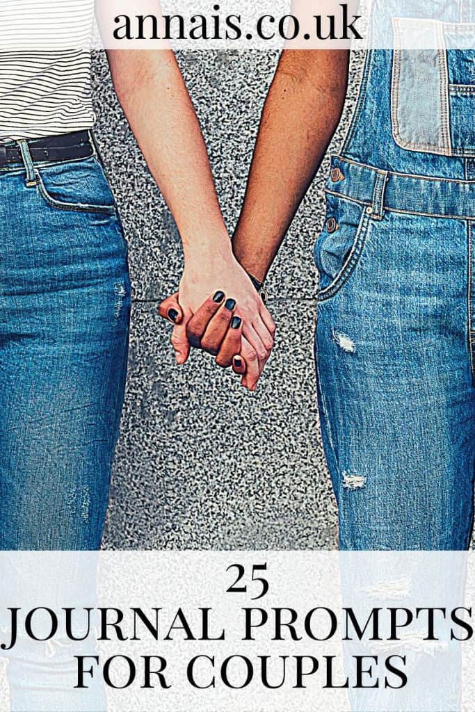 A couple stand against a wall holding hands - couples journal prompts